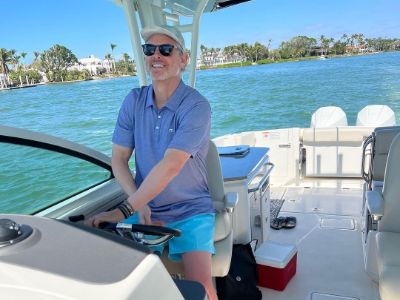 Colin Cowherd is driving a boat.